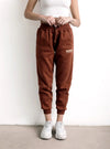 Pantalón jogger marrón para mujer con bolsillos y estampado 'SUNDAY', estilo casual.